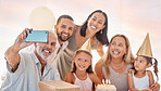 Party, family and birthday phone selfie with grandparents, parents and young children celebrating. Interracial, happy and celebration with birthday cake photograph of grandpa, grandma and kids.