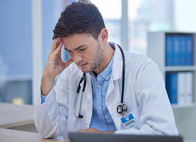 Buy stock photo Stress, headache and doctor with burnout sitting at his desk feeling depressed with in pain in hospital. Mental health, medicine and healthcare with frustrated male gp or physician feeling overworked