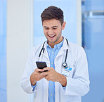 Doctor, man and phone with smile for texting, communication or chatting and good connection at hospital. Happy male healthcare or medical professional smiling for telecommunication service at clinic