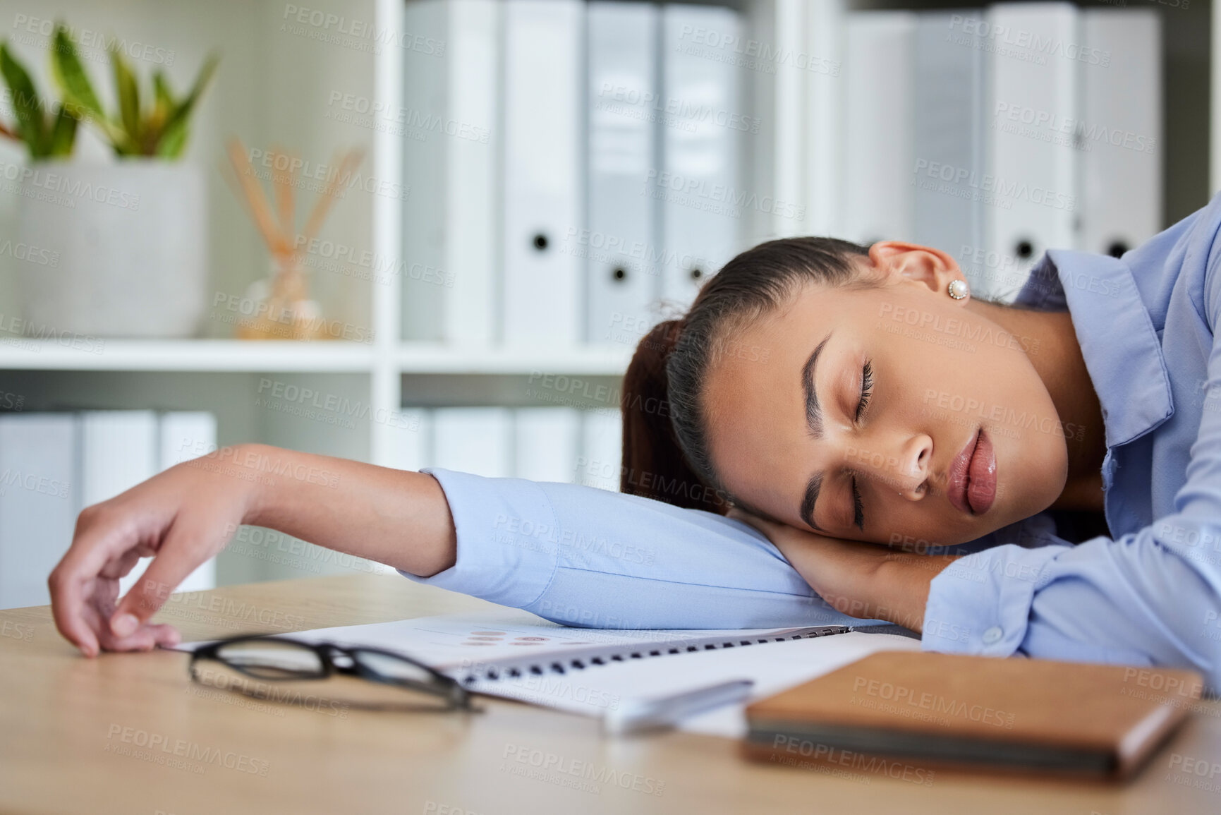 Buy stock photo Tired, sleep and woman in business on her table feeling burnout and overworked while sleeping in her office. Nap, dreaming and exhausted with fatigue businesswoman napping on her table at work