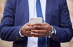 Business, man and phone in the hand of a finance accountant while trading online in the office. Financial, accounting and hands of a businessman browsing online on a cellphone for investments