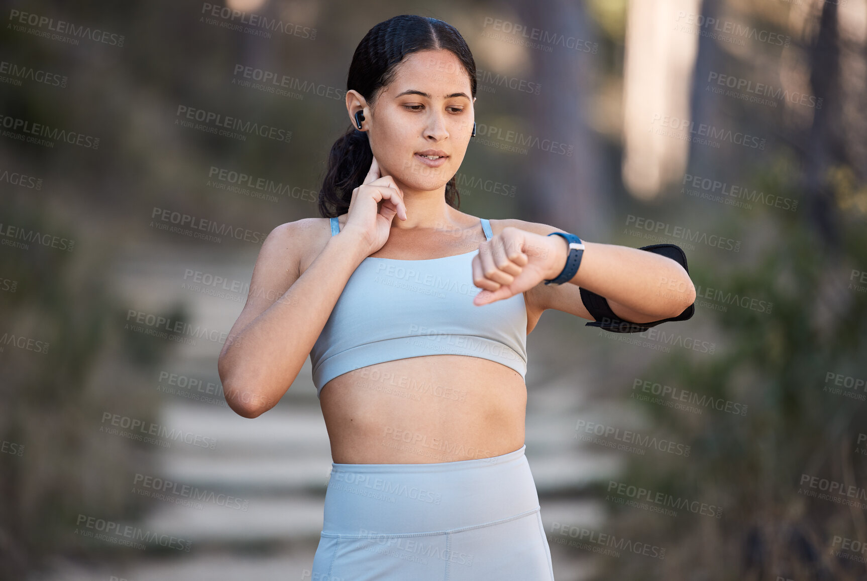 Buy stock photo Fitness, exercise and woman with smartwatch to check pulse, progress and performance while outdoor for running and cardio training. Female with watch for time on sports app during training in nature