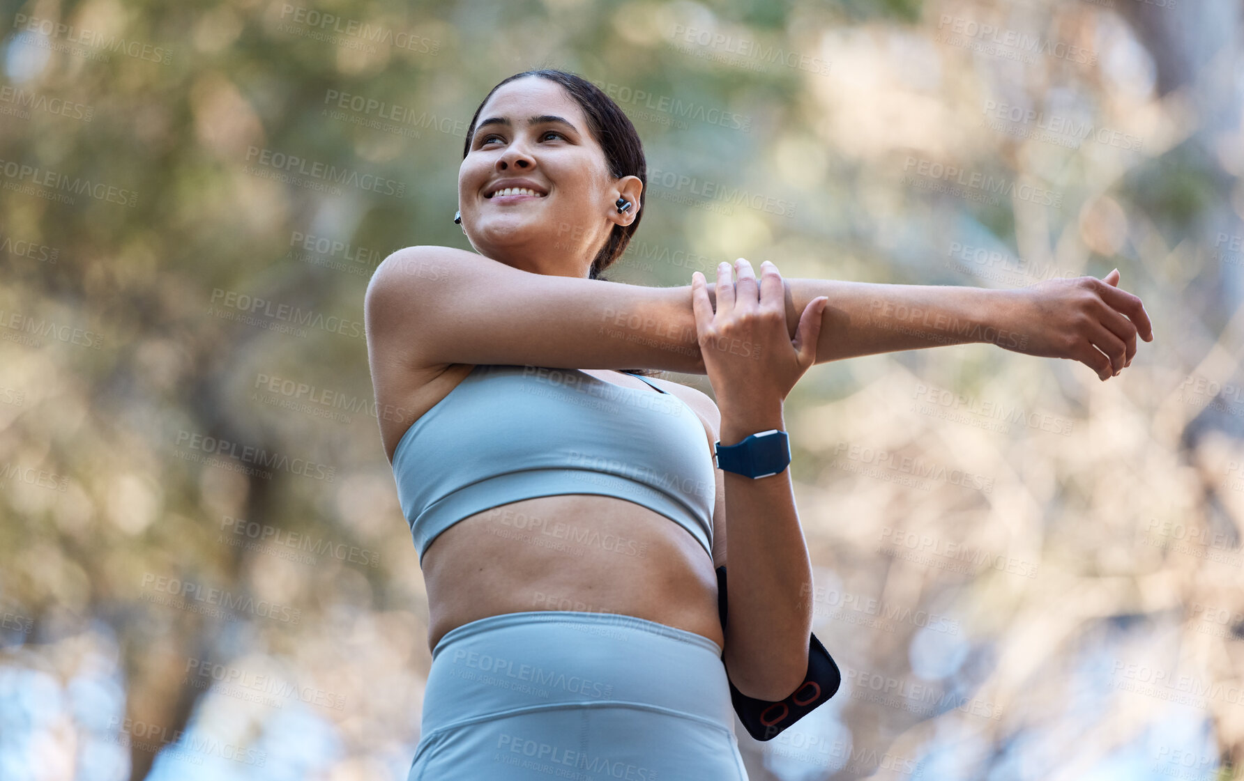 Buy stock photo Fitness, healthcare and woman stretching arm getting ready for training, exercise or workout. Sports, wellness and happy female runner warm up alone outdoors preparing for running, jog or marathon.