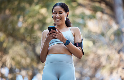 Buy stock photo Phone, earphones and woman in nature for fitness, running music or radio, podcast or audio outdoors. Wellness, health or female athlete on 5g mobile smartphone browsing social media on training break