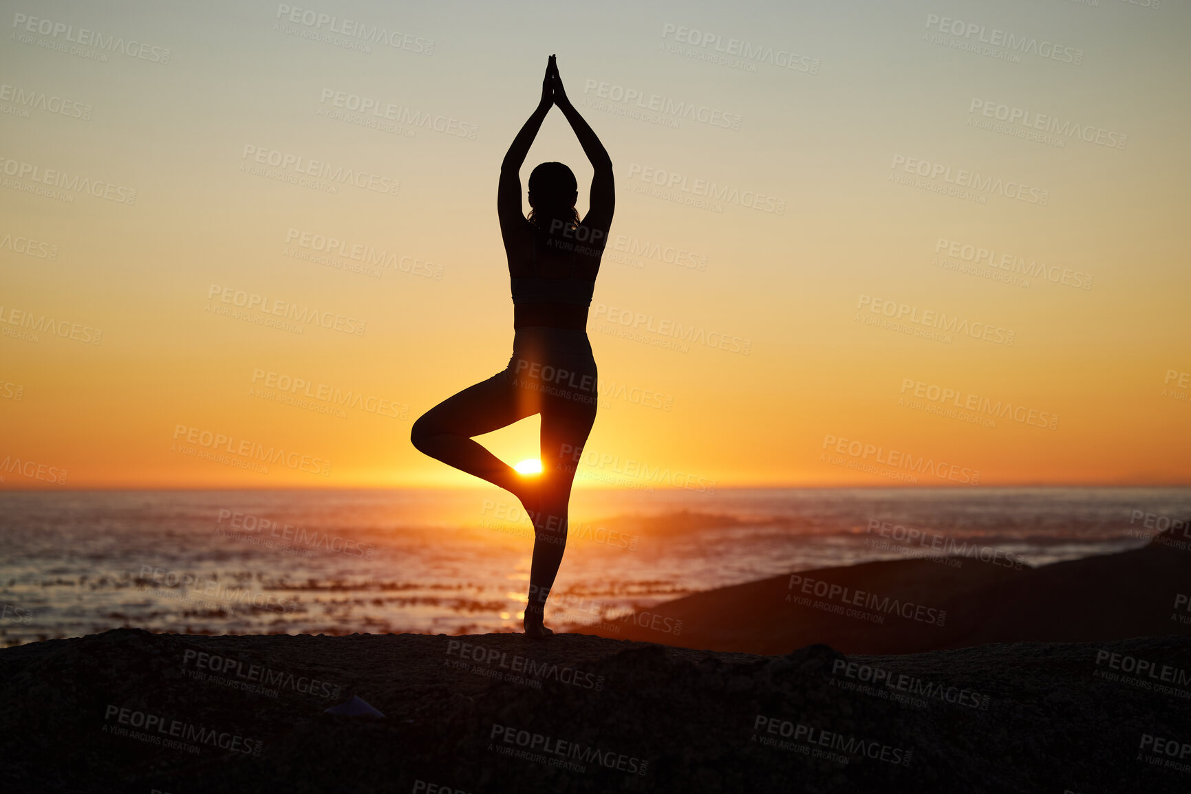 Buy stock photo Woman, silhouette or sunset yoga on beach by ocean, sea or water horizon for mental health, relax exercise or sun salutation. Calm, zen or peace yogi in tree pose at Bali nature for sunrise pilates 