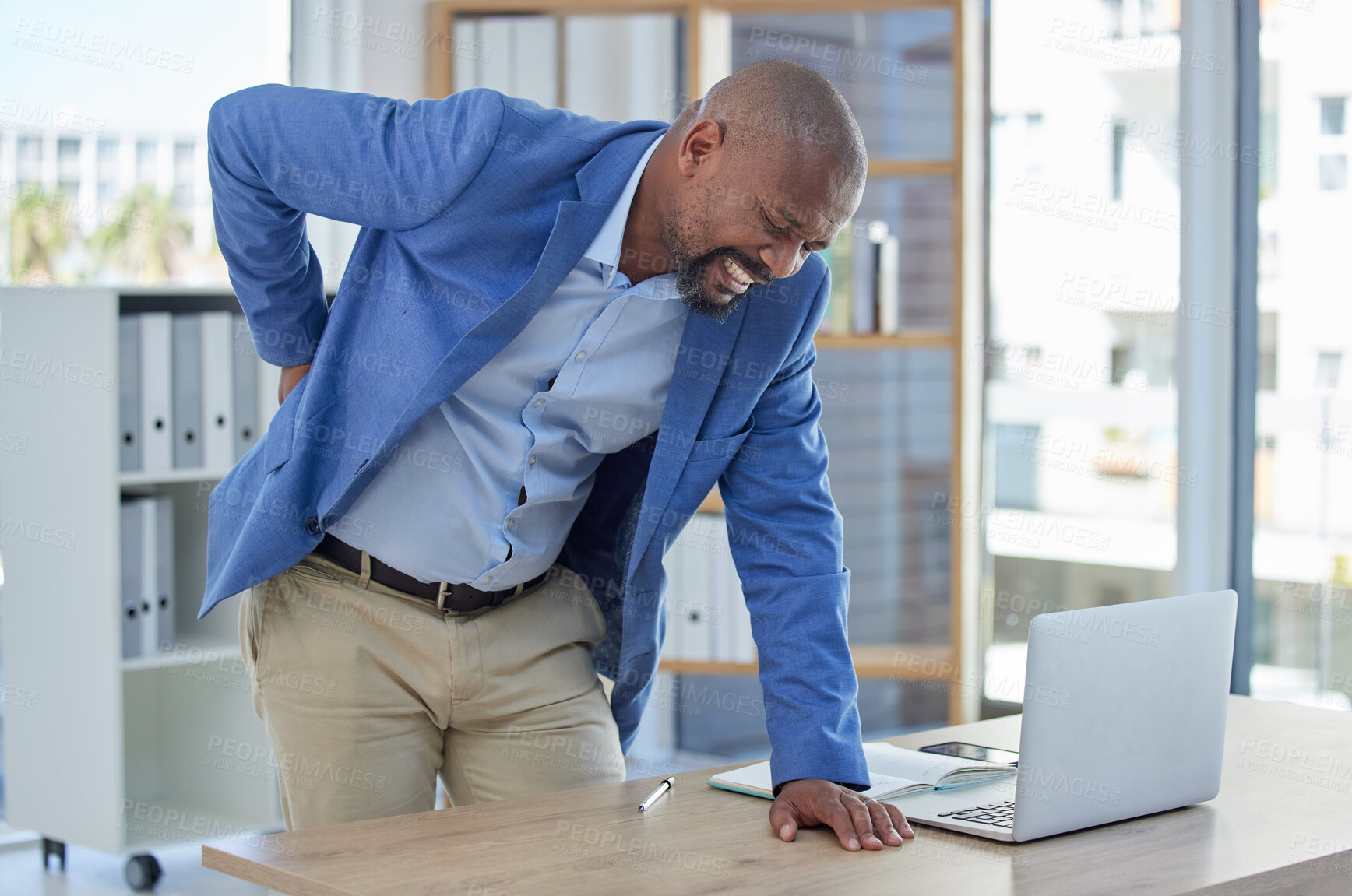 Buy stock photo Back pain, spine and injury with businessman at desk for burnout, muscle and fatigue. Overworked, stress and accident with black man and body ache for exhausted, tired and inflammation problem 