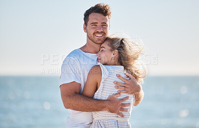 Buy stock photo Hug, love and couple at the beach for a date, travel and summer commitment together. Affection, happy and portrait of a man and woman hugging for comfort, happiness and marriage at the ocean