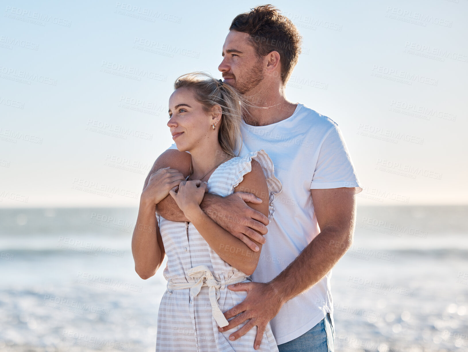 Buy stock photo Love, hug and happy couple at beach, travel holiday and anniversary, honeymoon and enjoy Hawaii together in summer. Young man, woman and vacation at ocean, sea and happiness, support and care outdoor