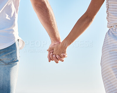 Buy stock photo Couple holding hands, blue sky and love together in nature, summer vacation and outdoor for save the date marriage relationship. Closeup hands of man, woman and travel in sunshine, relax and walking 