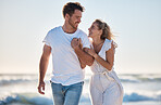 Holding hands, love and couple walking on beach during travel, freedom and quality time for support on holiday. Care, smile and man and woman on a vacation for marriage, relax and happy by the sea