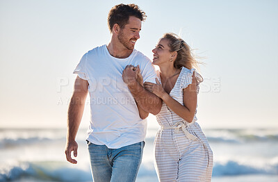Buy stock photo Holding hands, love and couple walking on beach during travel, freedom and quality time for support on holiday. Care, smile and man and woman on a vacation for marriage, relax and happy by the sea