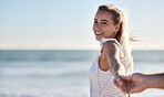 Holding hands, smile and couple walking on beach with support, love and care on a holiday. Summer, affection and portrait of a woman with the hand of a man for trust, travel and adventure by the sea
