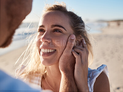Buy stock photo Woman, face and man hand for love, support and care, together on beach and holiday in summer. Couple, trust and happy relax vacation for honeymoon, quality time or marriage with husband holding wife