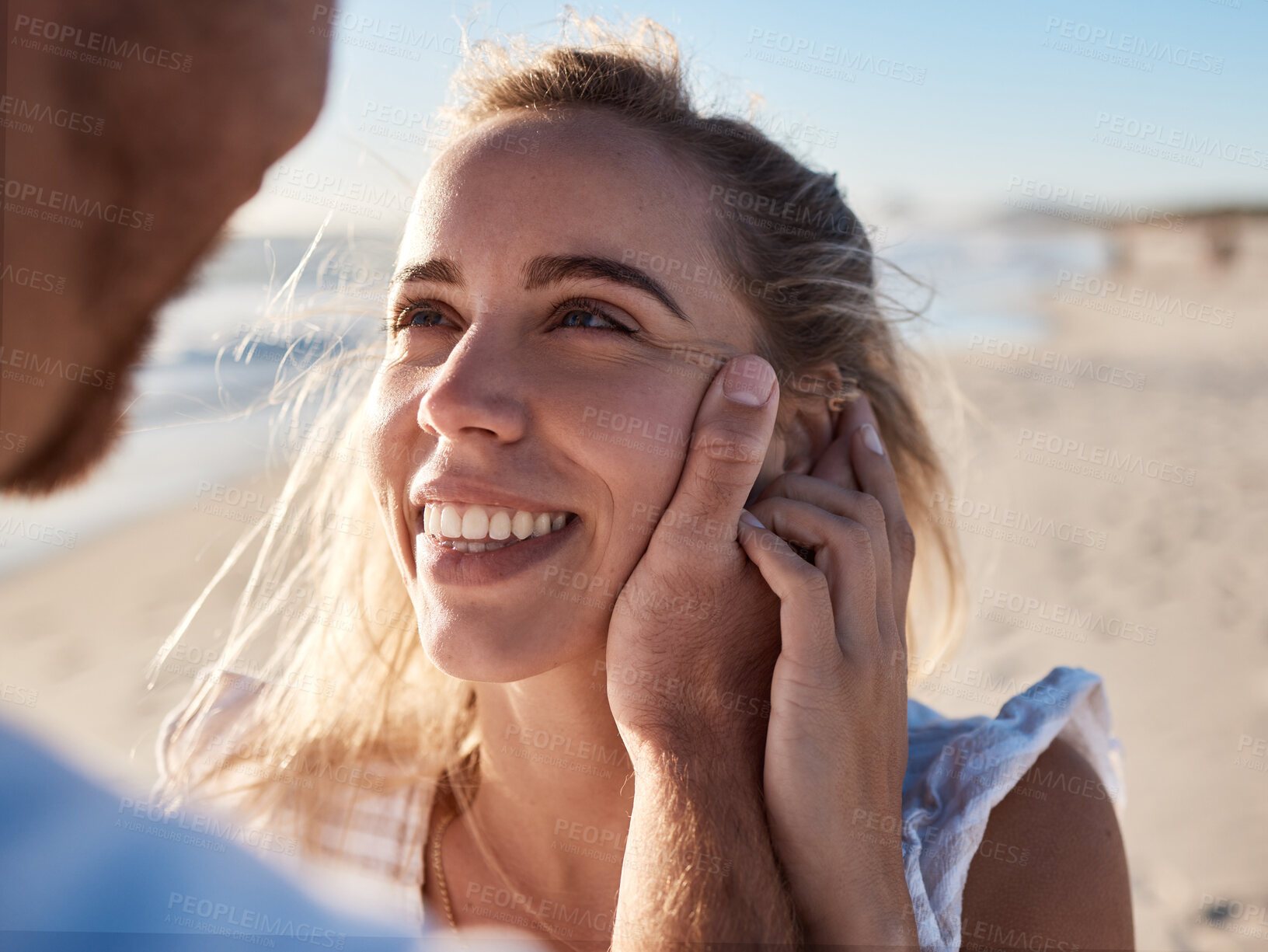 Buy stock photo Woman, face and man hand for love, support and care, together on beach and holiday in summer. Couple, trust and happy relax vacation for honeymoon, quality time or marriage with husband holding wife