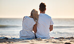 Beach, love and couple relaxing on the sand while watching the ocean waves together on vacation. Travel, romantic and man and woman on seaside holiday to bond, relax and rest by the sea in Australia.