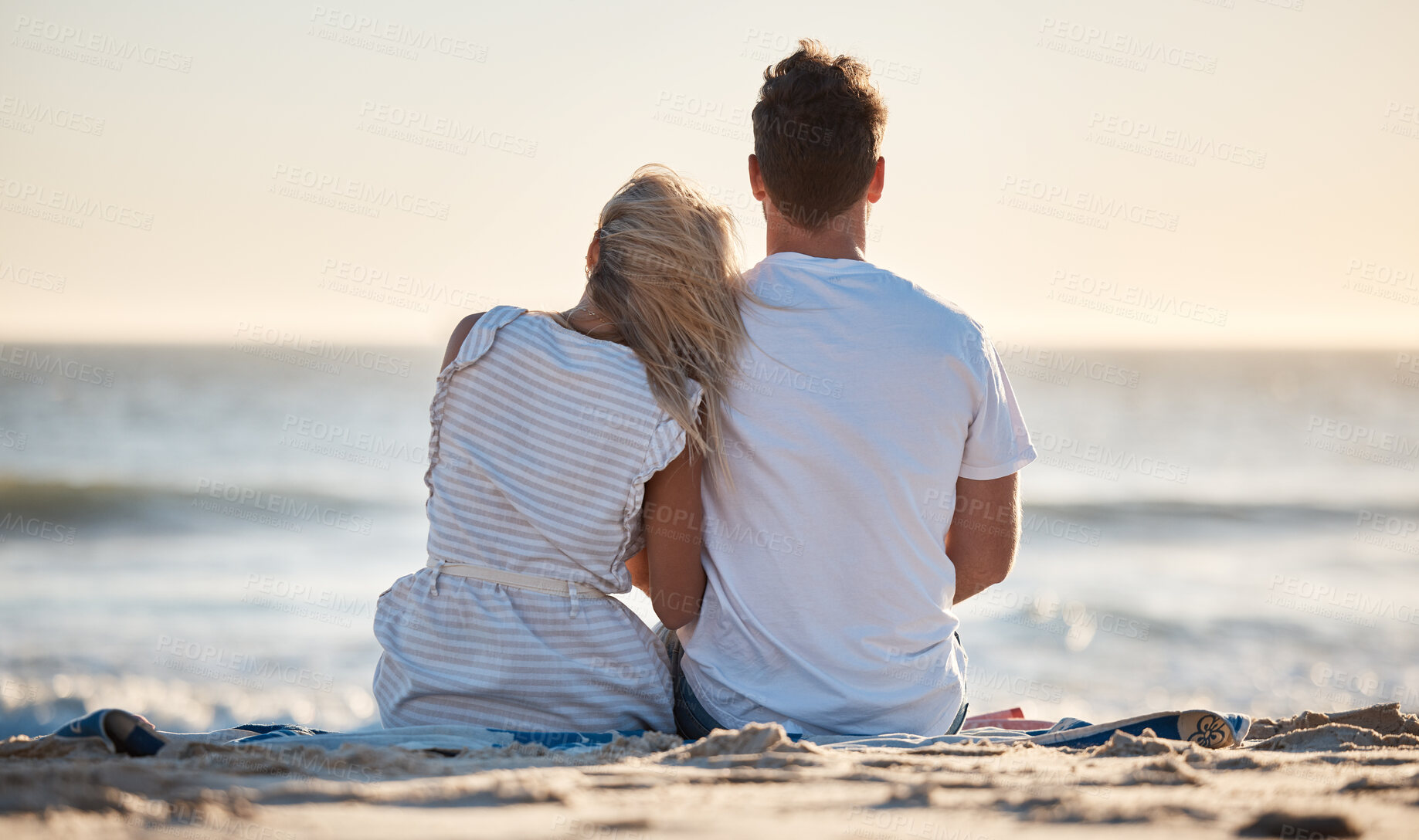 Buy stock photo Beach, love and couple relaxing on the sand while watching the ocean waves together on vacation. Travel, romantic and man and woman on seaside holiday to bond, relax and rest by the sea in Australia.