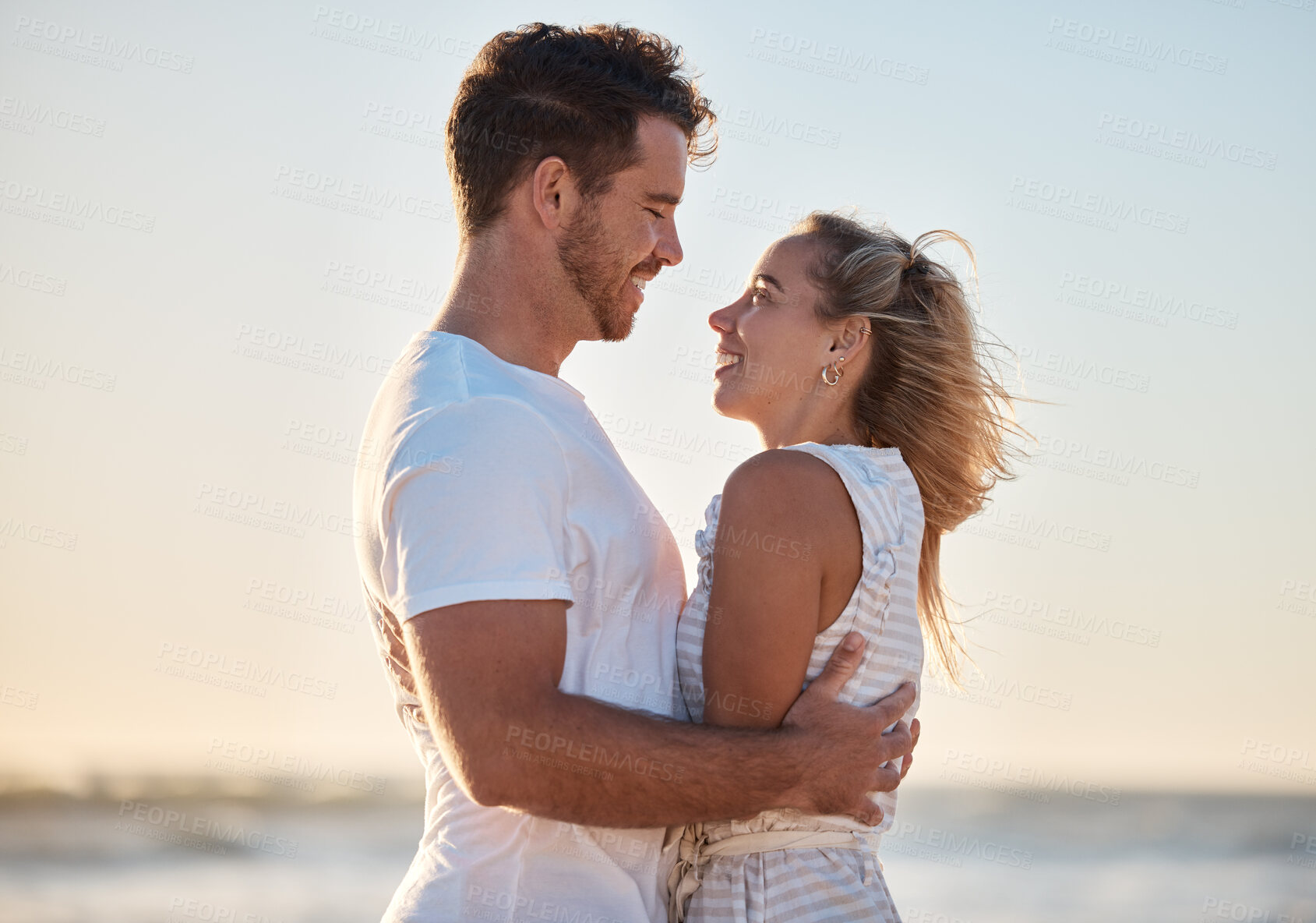 Buy stock photo Couple, travel and hug with love and beach holiday, romantic vacation and happy together at sunrise. Man, woman and care with adventure by the ocean, outdoor and nature for bonding and romance.
