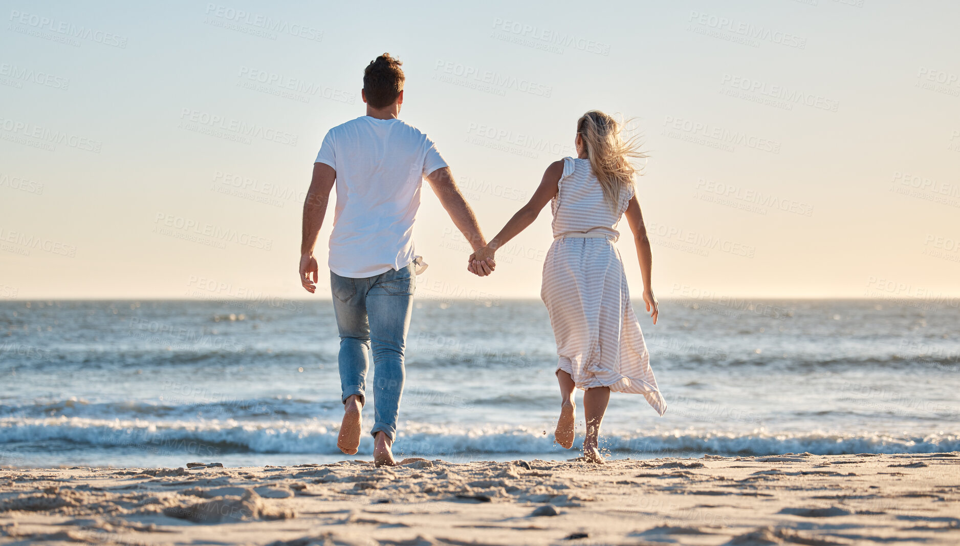 Buy stock photo Couple, hand holding and vacation at beach, love and trust together with travel and adventure with nature and ocean view. Man, woman bonding and back view, support with sea, sand and romantic holiday