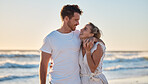 Sunset beach, love and summer with a couple hug on the sand by the sea or ocean while on holiday together. Happy, smile and romance with man and woman bonding while on travel vacation or break at sea
