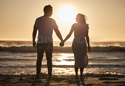 Buy stock photo Beach silhouette, couple holiday and sunset with love, hold hands and love together, support and holiday. Man, woman and vacation at ocean, travel and romance for anniversary, honeymoon and sea trip