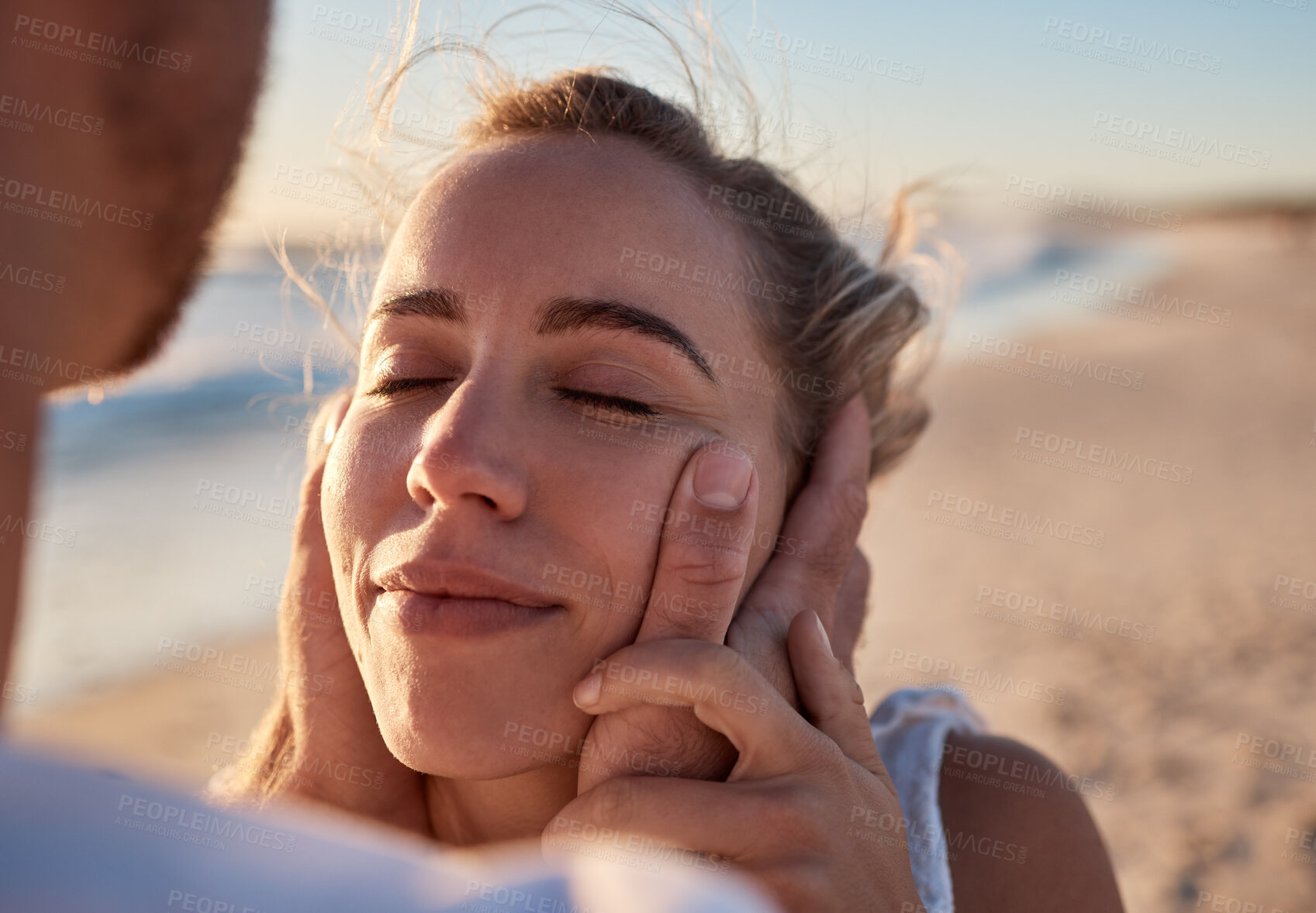 Buy stock photo Woman, face and hands for couple at beach for romance, relax or embracing happy relationship together. Happy female with smile relaxing in loving care or enjoying summer vacation love by the ocean