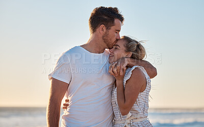 Buy stock photo Love, summer and couple kiss at beach for intimacy, romance and loving relationship on honeymoon. Dating, affection and man and woman bonding and enjoy holiday, vacation and weekend together by ocean