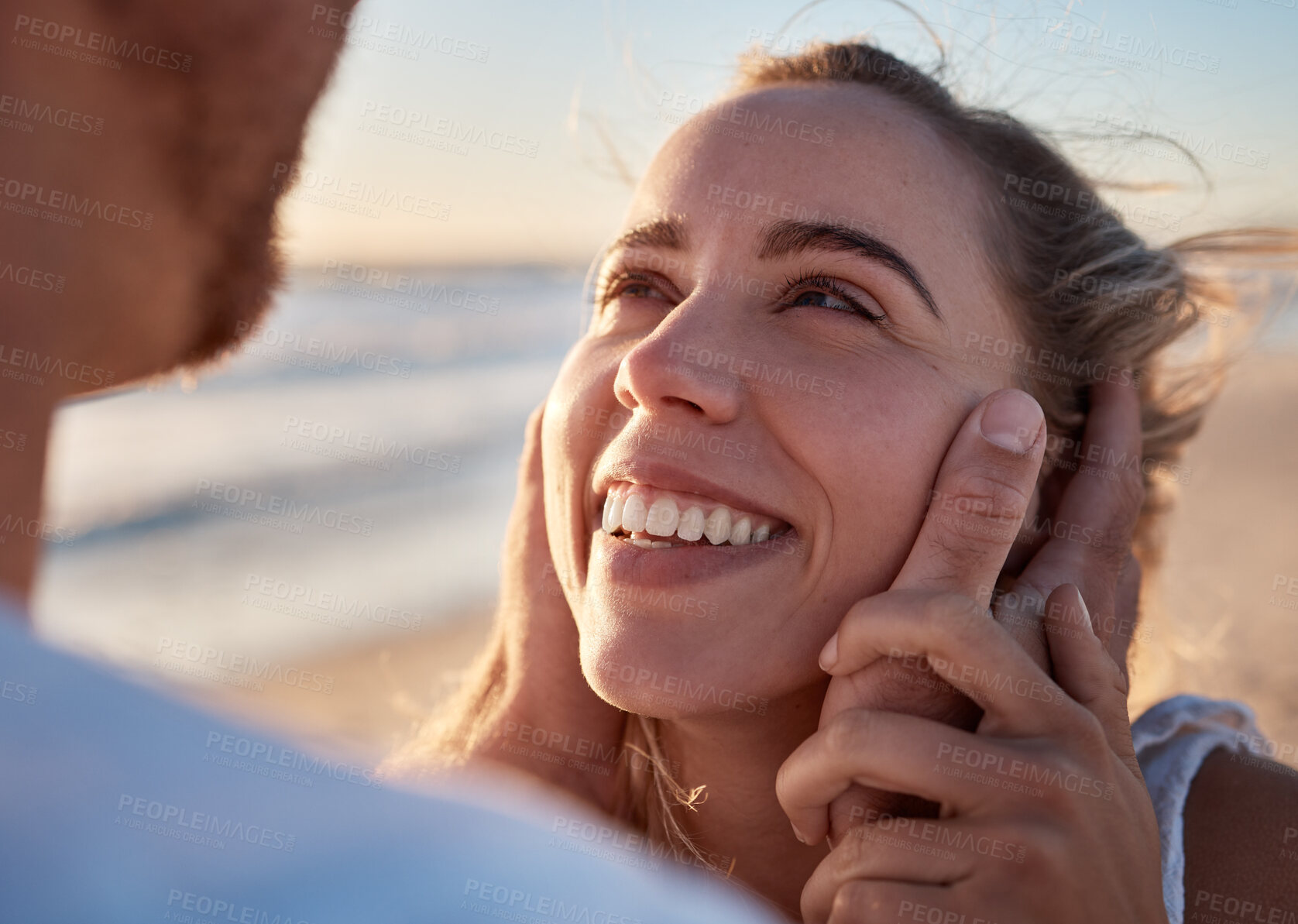Buy stock photo Face in hands, couple and love with trust and care, travel to beach on romantic vacation for bonding and relationship. Happy, woman smile at man with romance and adventure, date or holiday by ocean.