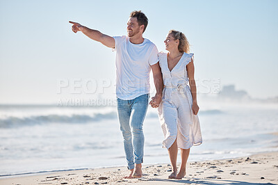 Buy stock photo Couple, beach and travel holiday, love and happy smile, anniversary and date while walking, holding hands and point. Man, woman and summer vacation, happiness and together in nature and marriage life