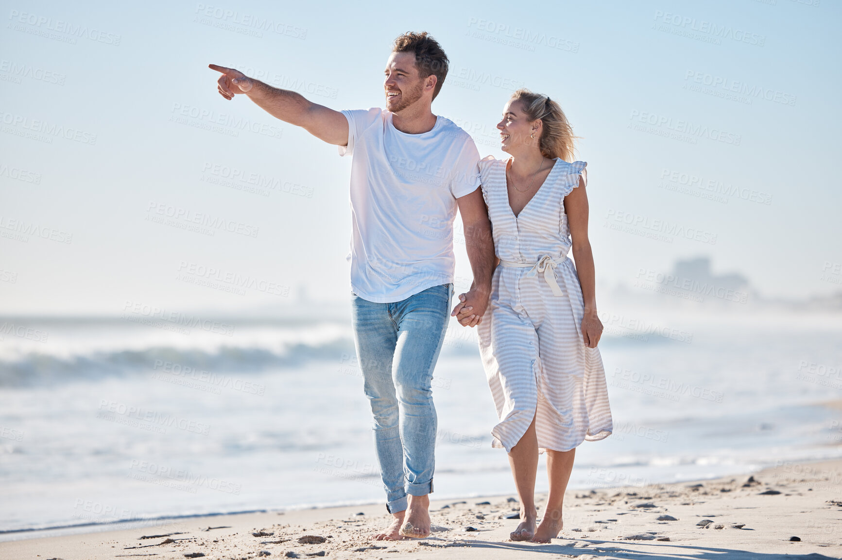 Buy stock photo Couple, beach and travel holiday, love and happy smile, anniversary and date while walking, holding hands and point. Man, woman and summer vacation, happiness and together in nature and marriage life