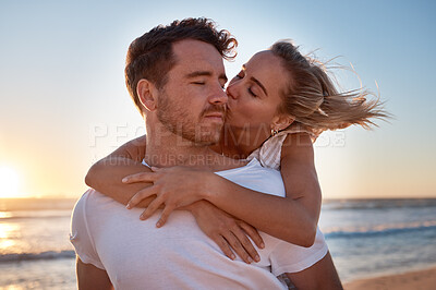 Buy stock photo Love, couple and cheek kiss at beach on date, vacation or summer trip. Sunset, affection or romance of man and woman kissing at seashore, bonding and enjoying quality time together outdoors at coast.
