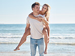 Love, summer and couple doing piggyback at the beach enjoying romantic holiday, vacation and honeymoon by sea. Nature, affection and man carrying woman by ocean bonding, smiling and happy together