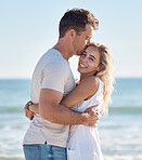 Couple, beach and hug bonding with a kiss, love and care happy about anniversary and commitment. Portrait of a girlfriend and boyfriend together on summer vacation smile feeling freedom on holiday