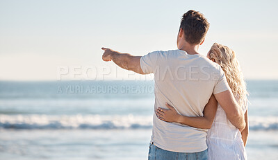 Buy stock photo Couple, love and relax hug on beach with back view for freedom travel vacation or holiday in summer. Ocean, man point and woman on sea sand for romance, quality time and marriage bonding together