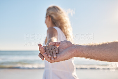 Buy stock photo Holding hands, support and couple walking by beach for love, trust and quality time in marriage. Travel, tropical and man and woman on a walk by the sea to relax on holiday by the water in Bali
