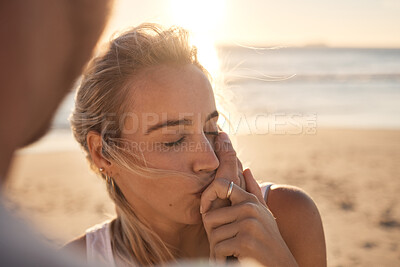 Buy stock photo Couple, love and kiss hand at beach during sunset, travel and romance for relationship bonding and trust. Affection, romantic and woman kissing hands at sunset, holiday by the ocean and lens flare.