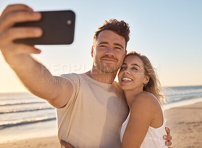 Buy stock photo Phone, selfie and happy couple on the beach on vacation for their romantic honeymoon celebration. Happiness, love and young man and woman taking picture together by the ocean or sea while on holiday.