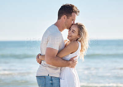 Buy stock photo Love, kiss and happy couple hugging on a beach while on a romantic summer vacation together in Australia. Travel, freedom and young man and woman embracing in nature by the ocean on honeymoon holiday