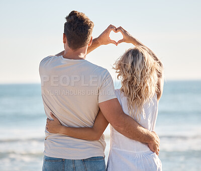 Buy stock photo Love, heart and hands of couple at beach for travel destination, happy and summer break. Nature, trust and wellness with man and woman bonding by ocean shoreline for support, peace and adventure