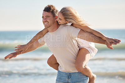Buy stock photo Couple, freedom and love at the beach, together and piggyback on adventure with travel and ocean. Trust, relationship and man with happy woman, seaside vacation with arms out and care free.