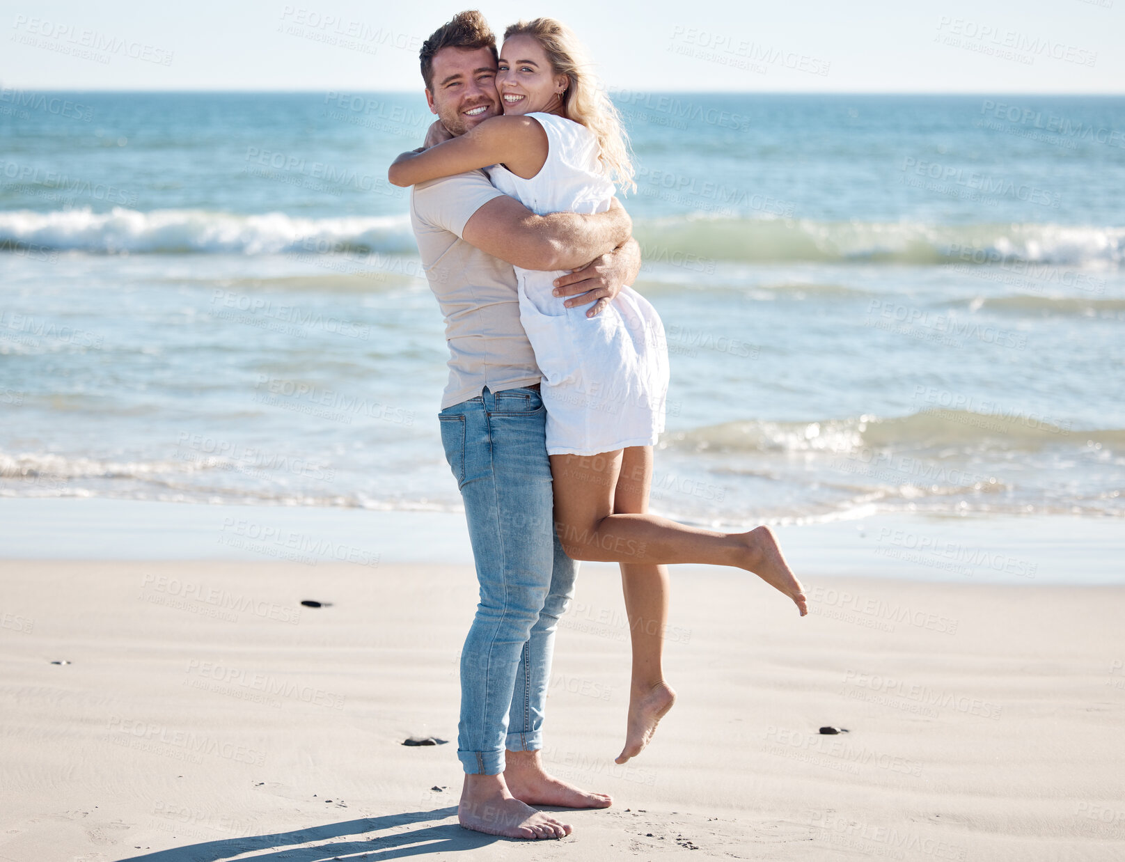 Buy stock photo Hug, love and portrait of a couple on the beach on a summer vacation, adventure or journey. Happiness, smile and romantic man and woman embracing by the ocean while on a date on seaside holiday.