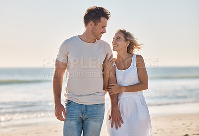 Buy stock photo Travel, love and couple at the beach at sunset, walking and relax along the ocean, bond and happy together. Freedom, woman and man walk at a sea, smile and enjoy relationship, holiday and Cancun trip