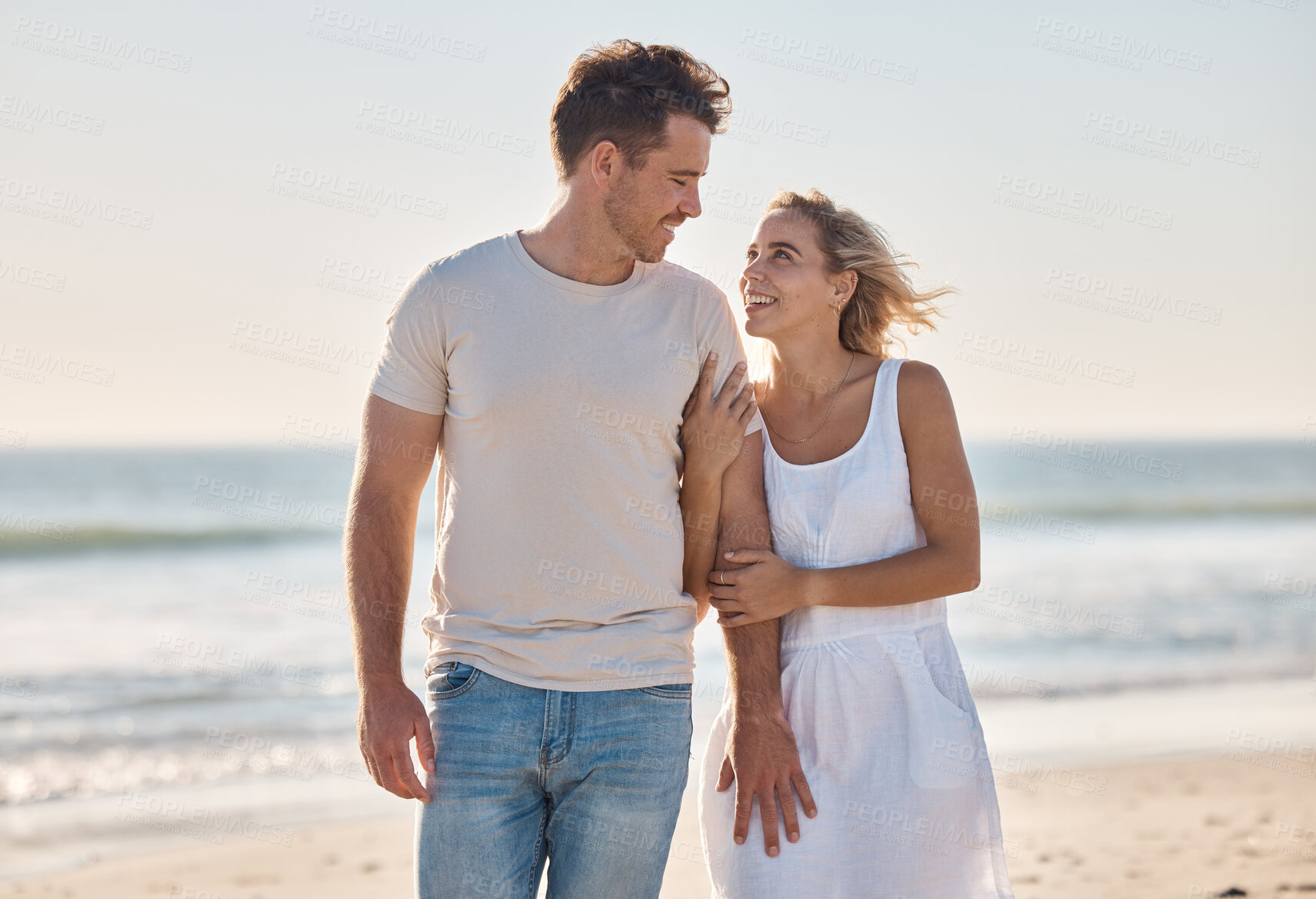Buy stock photo Travel, love and couple at the beach at sunset, walking and relax along the ocean, bond and happy together. Freedom, woman and man walk at a sea, smile and enjoy relationship, holiday and Cancun trip