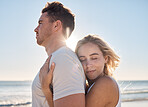 Love, couple and hug on beach holiday, vacation or summer date outdoors. Affection, romance and smile of man and woman on honeymoon, embrace and enjoying quality time together at seashore or coast.