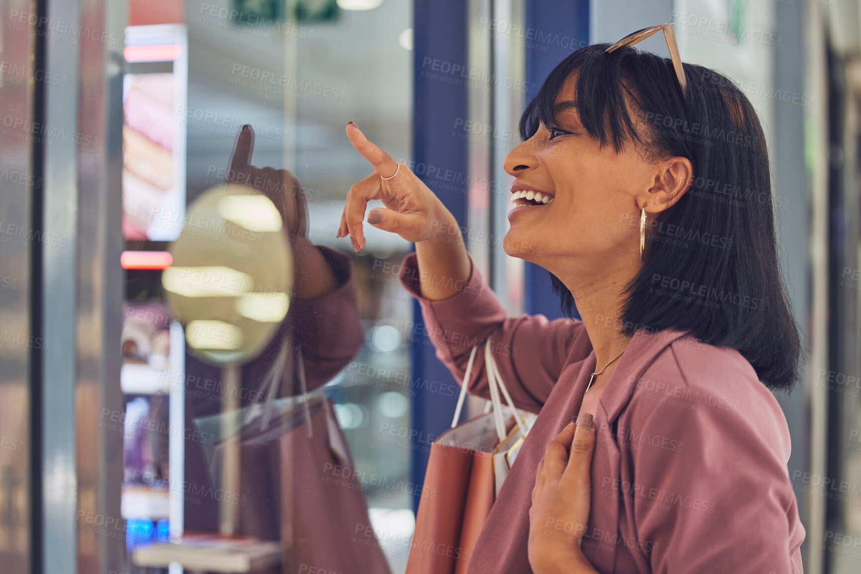 Buy stock photo Happy woman, window and shopping, mall and excited to buy sales, discount products and luxury fashion clothes. Smile customer pointing in glass, shopping mall and choice, decision and retail boutique