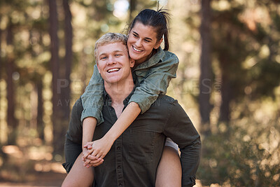 Buy stock photo Couple, hug and smile for piggyback in nature walk, love and support for fun relationship bonding together. Portrait of happy man carrying woman smiling and enjoying quality time in the outdoors