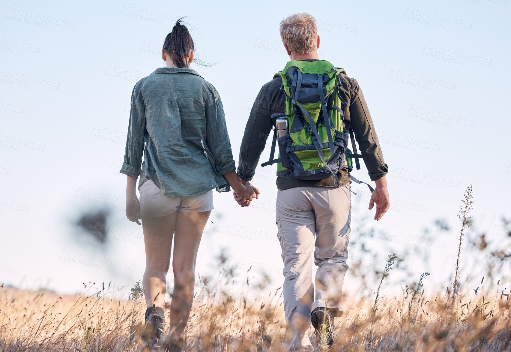 Buy stock photo Couple, holding hands and travel or backpack adventure in bonding relationship together in the countryside. Hands of man and woman backpacking, trekking or walking in care or support for traveling