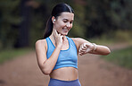 Fitness, runner and woman checking watch for pulse, time or heart rate after running exercise or workout in nature. Athletic female monitoring physical wellness or training performance on smart watch