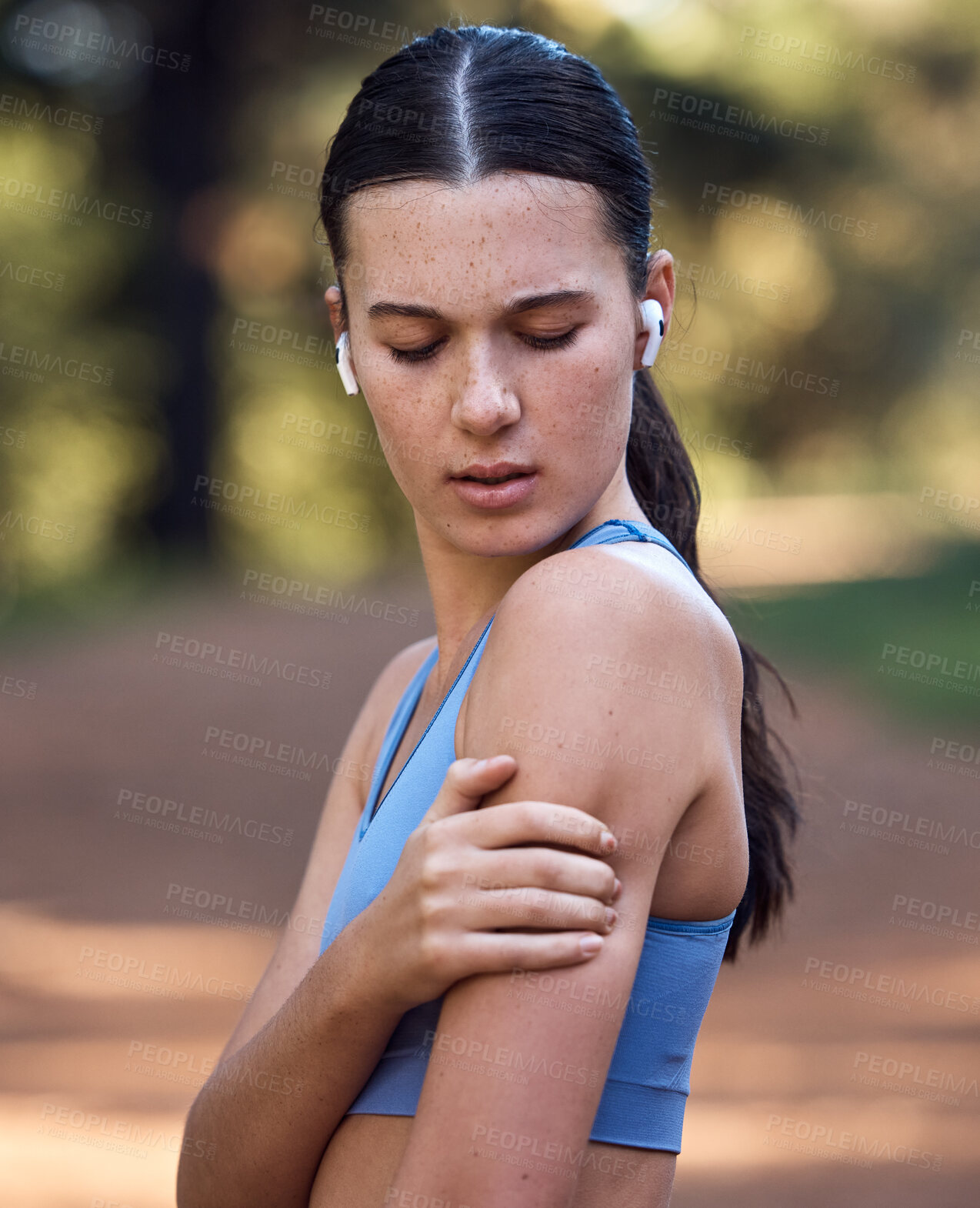 Buy stock photo Woman, earphones and fitness shoulder pain in nature environment workout, sustainability woods training or forest exercise. Runner, sports athlete and arm injury in muscle stress, burnout and crisis