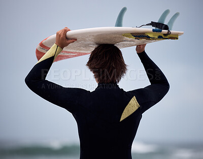 Surfer, surfboard and surfing ocean on waves for fitness exercise, leisure and water sport training exercise. Beach surf, man in wetsuit and fun sea freedom workout in Australia for summer wellness