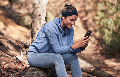 Buy stock photo Fitness, woman with smartphone and earphones for music search, run in the woods with technology and audio streaming for workout. Wellness, happy and runner with radio app and exercise outdoor.